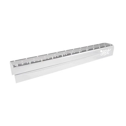 Angled view of an empty clear acrylic wall-mountable dart holder showing laser-etched Shot logo.