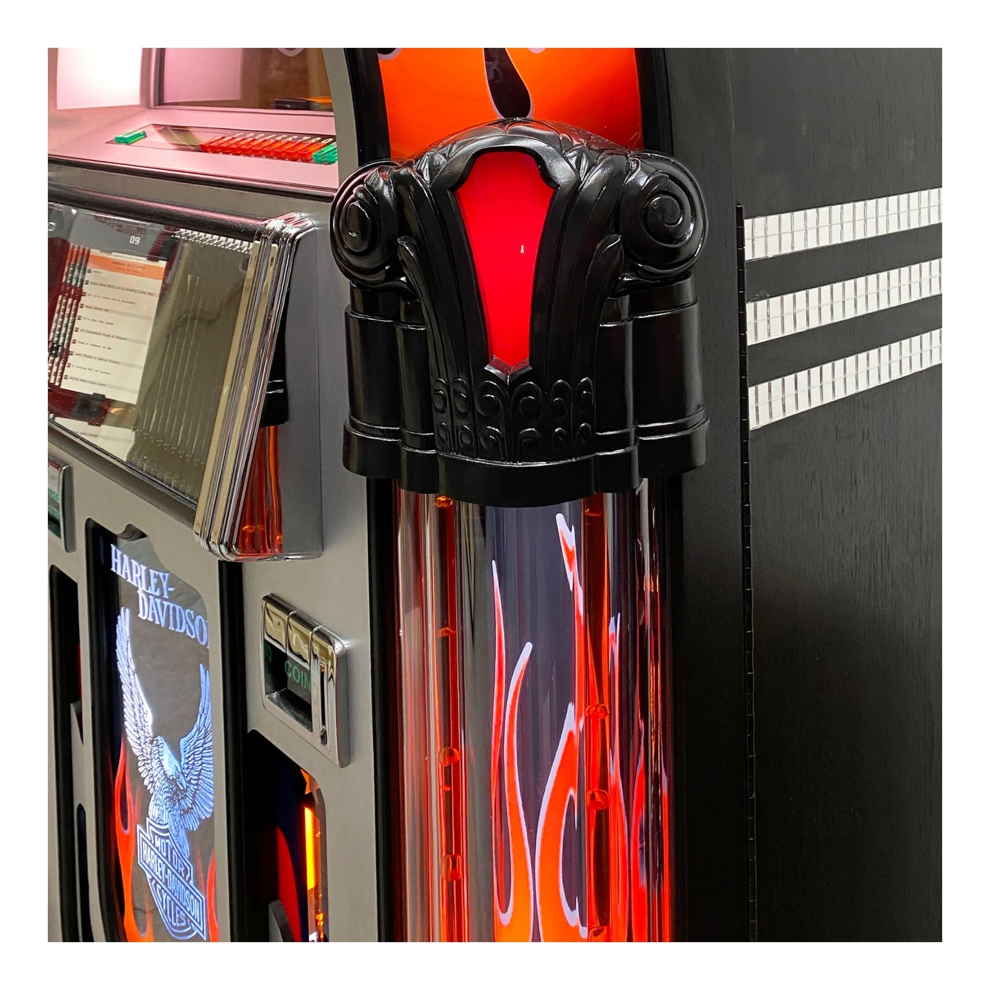 Close-up of a Harley-Davidson branded arcade machine with red and black design.