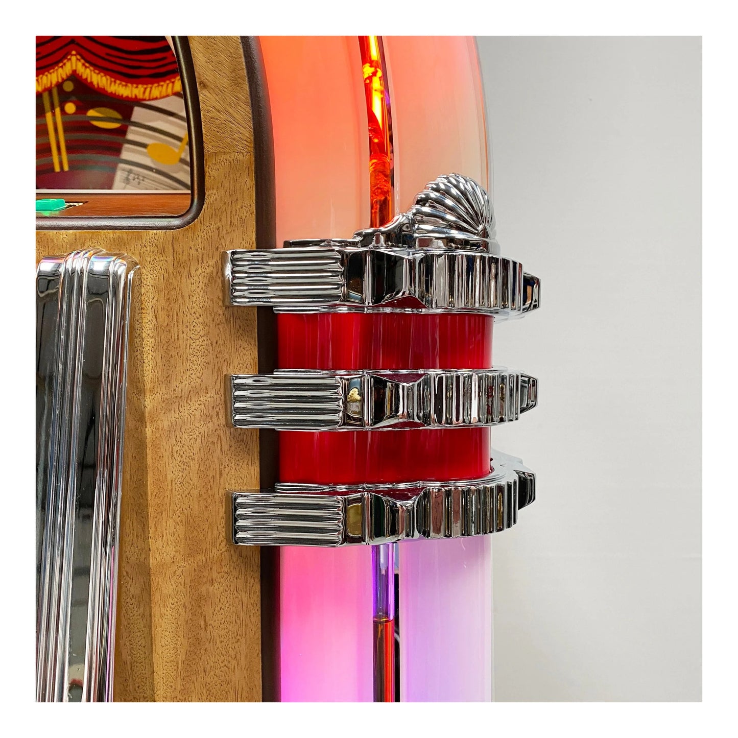 Close-up of a vintage car emblem with chrome details on a colorful background