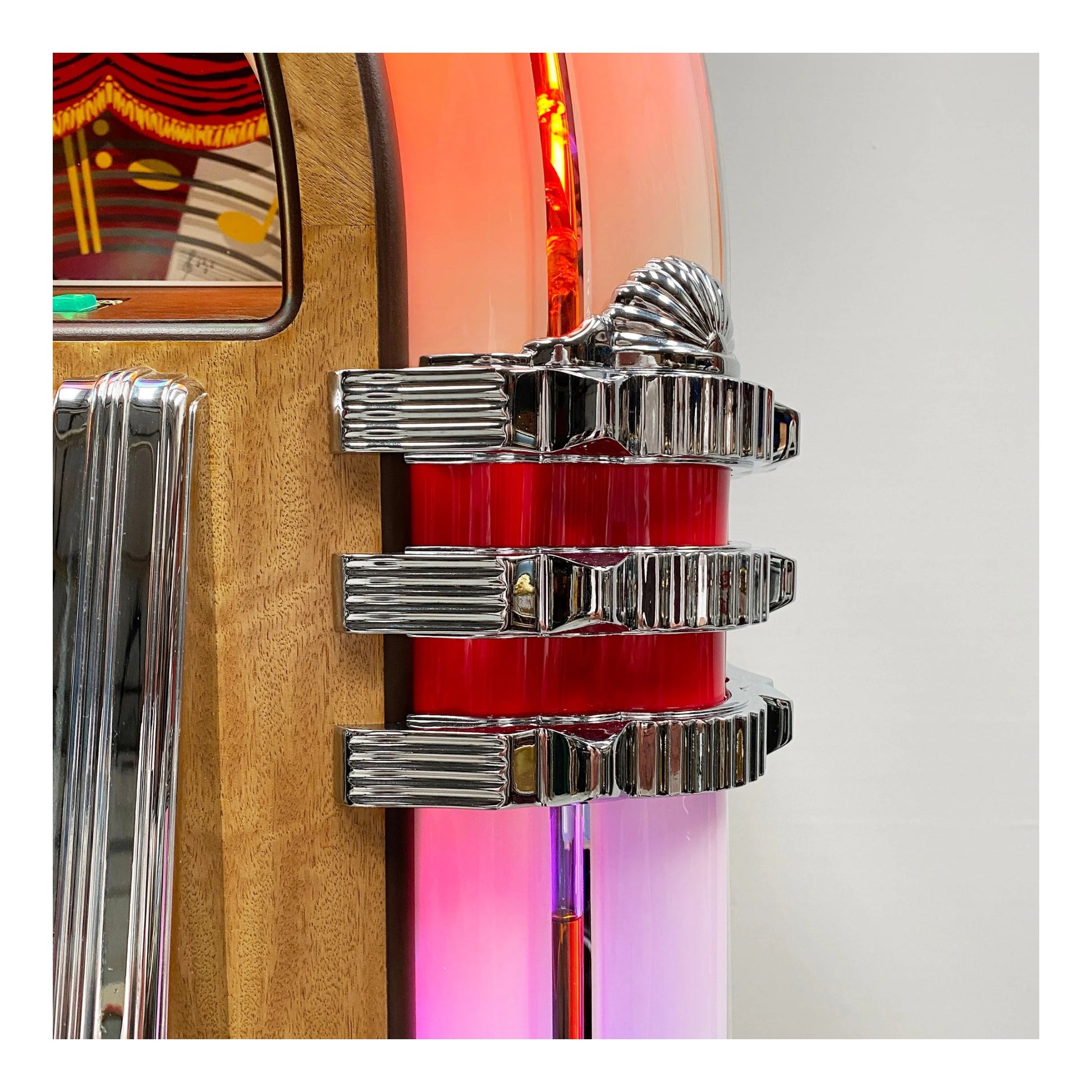 Close-up of a vintage car emblem with chrome details on a colorful background