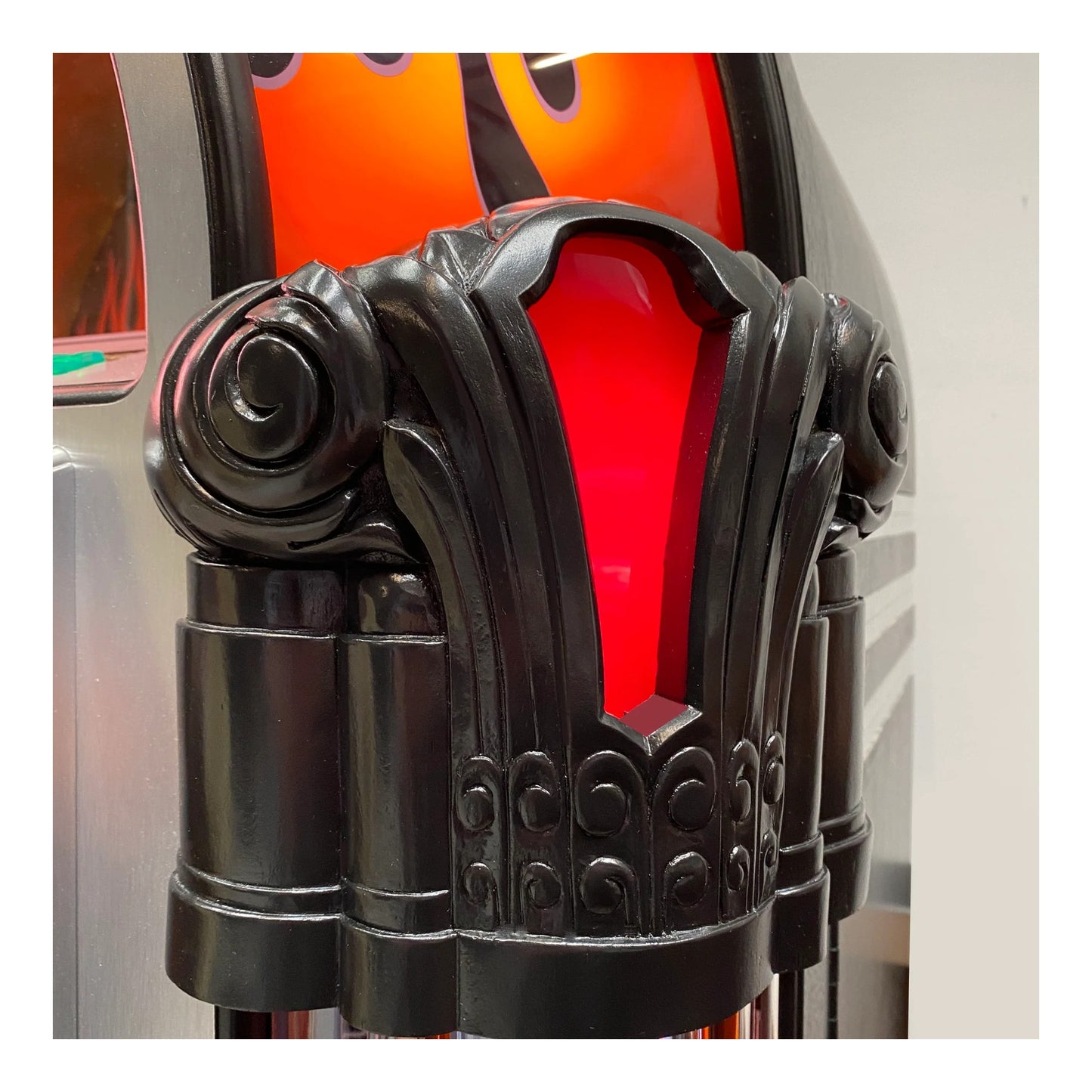 Decorative black metal lamp with red glass shade on a white background