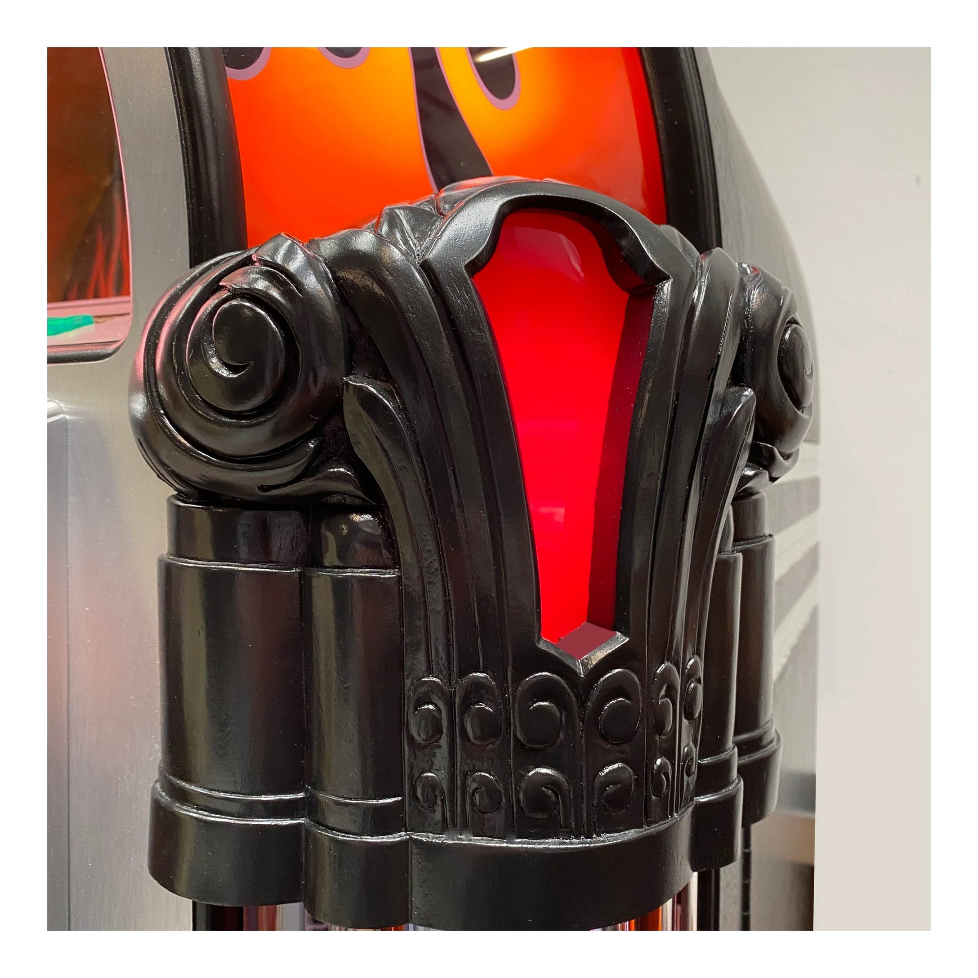 Decorative black metal lamp with red glass shade on a white background