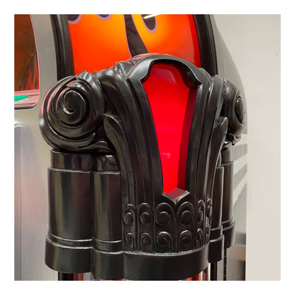 Decorative black metal lamp with red glass shade on a white background