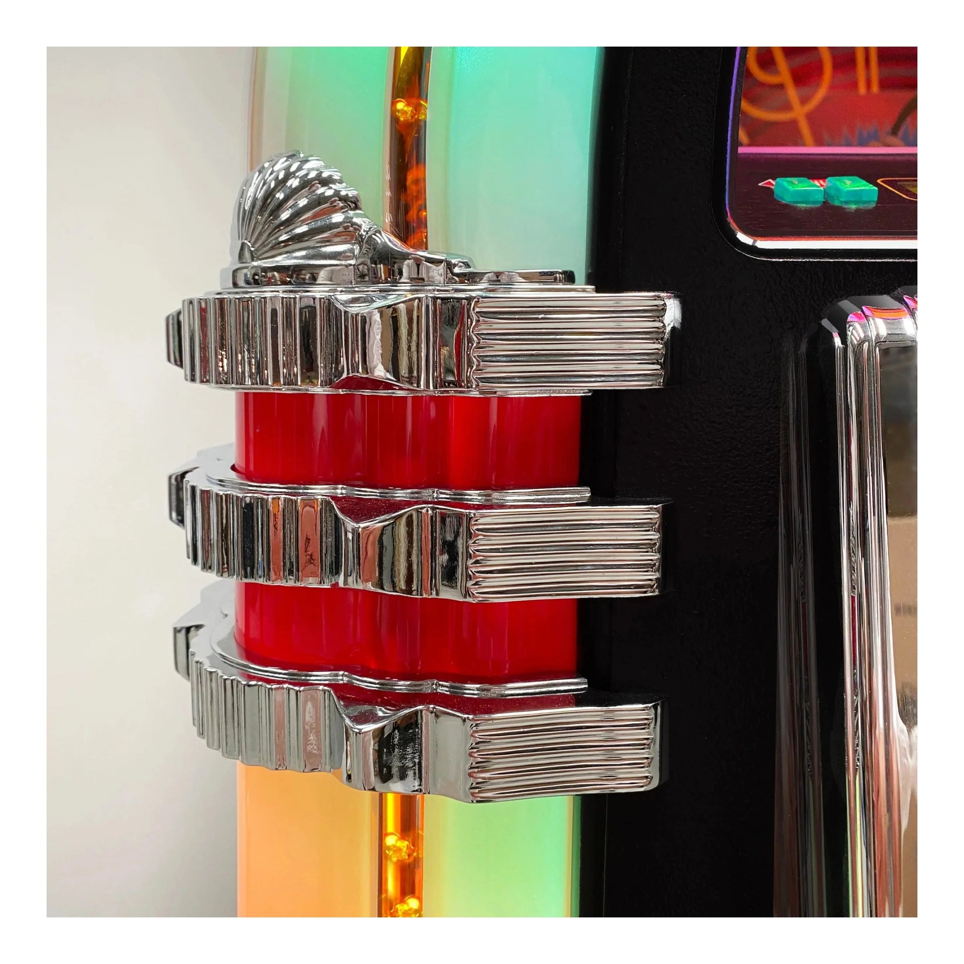 Close-up of a decorative car emblem with red and silver design on a blurred background