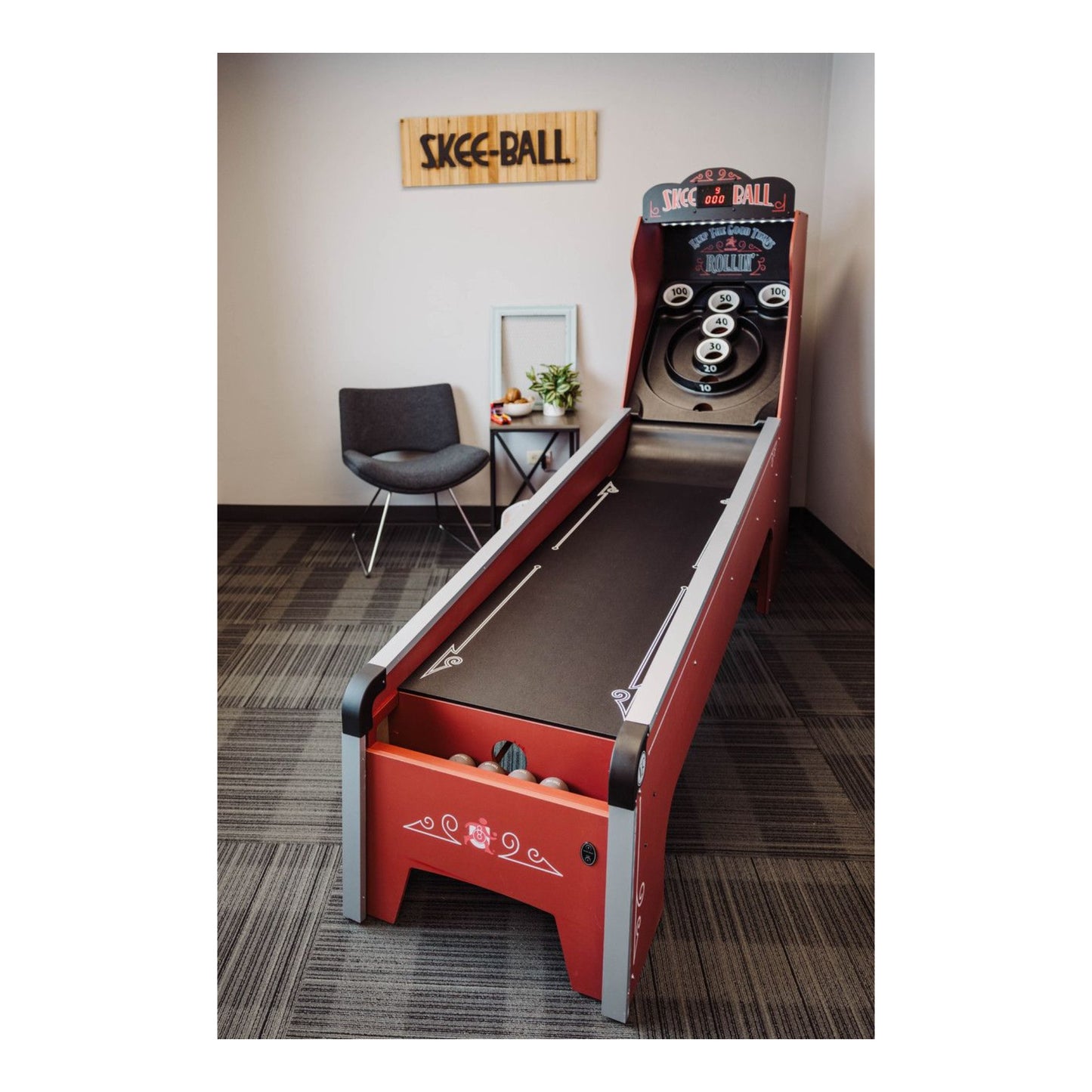 Full view of the authentic Skee-Ball Home Arcade Deluxe machine in a family game room