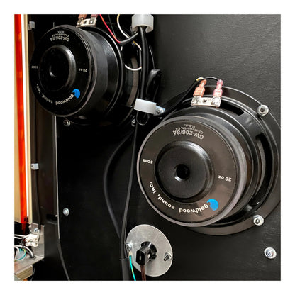 Close-up of a speaker with 'Polk Audio' branding on a black background