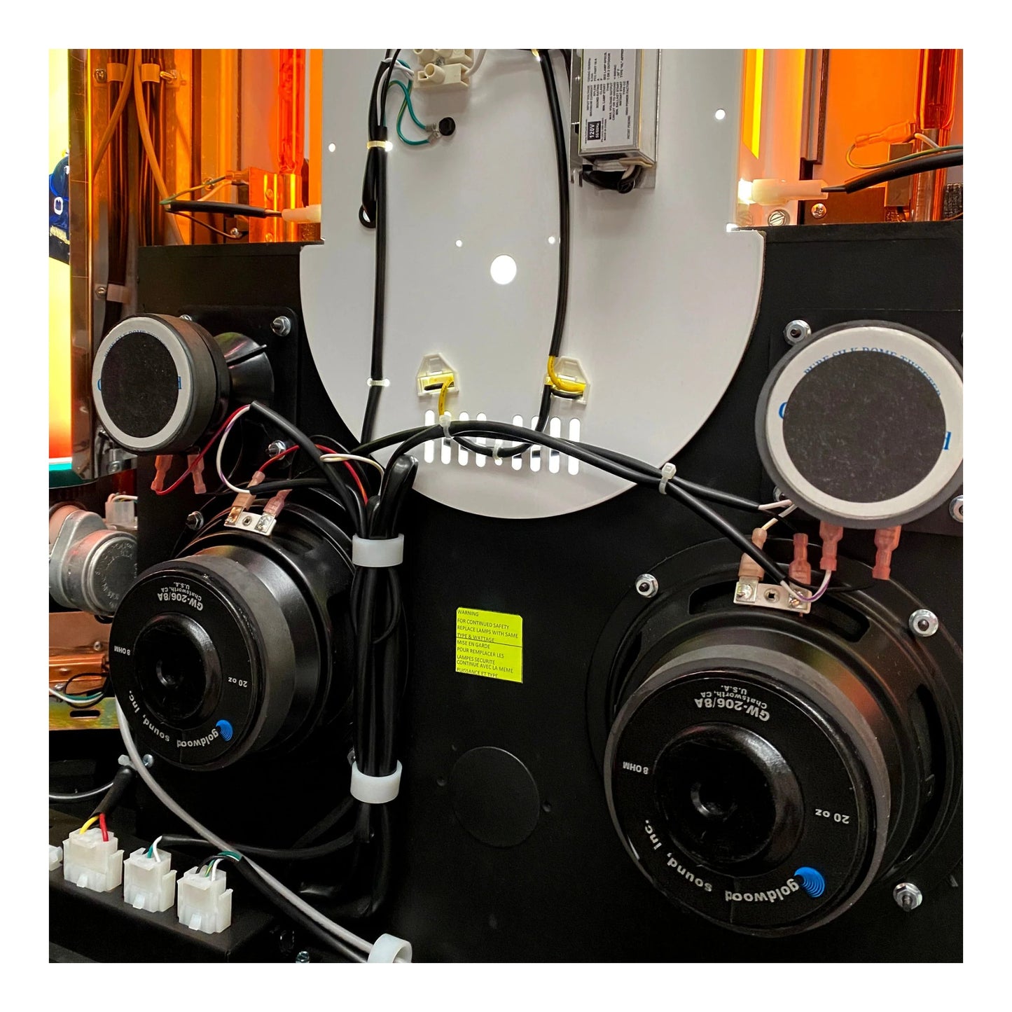 Close-up of a mechanical system with speakers and wiring in an industrial setting