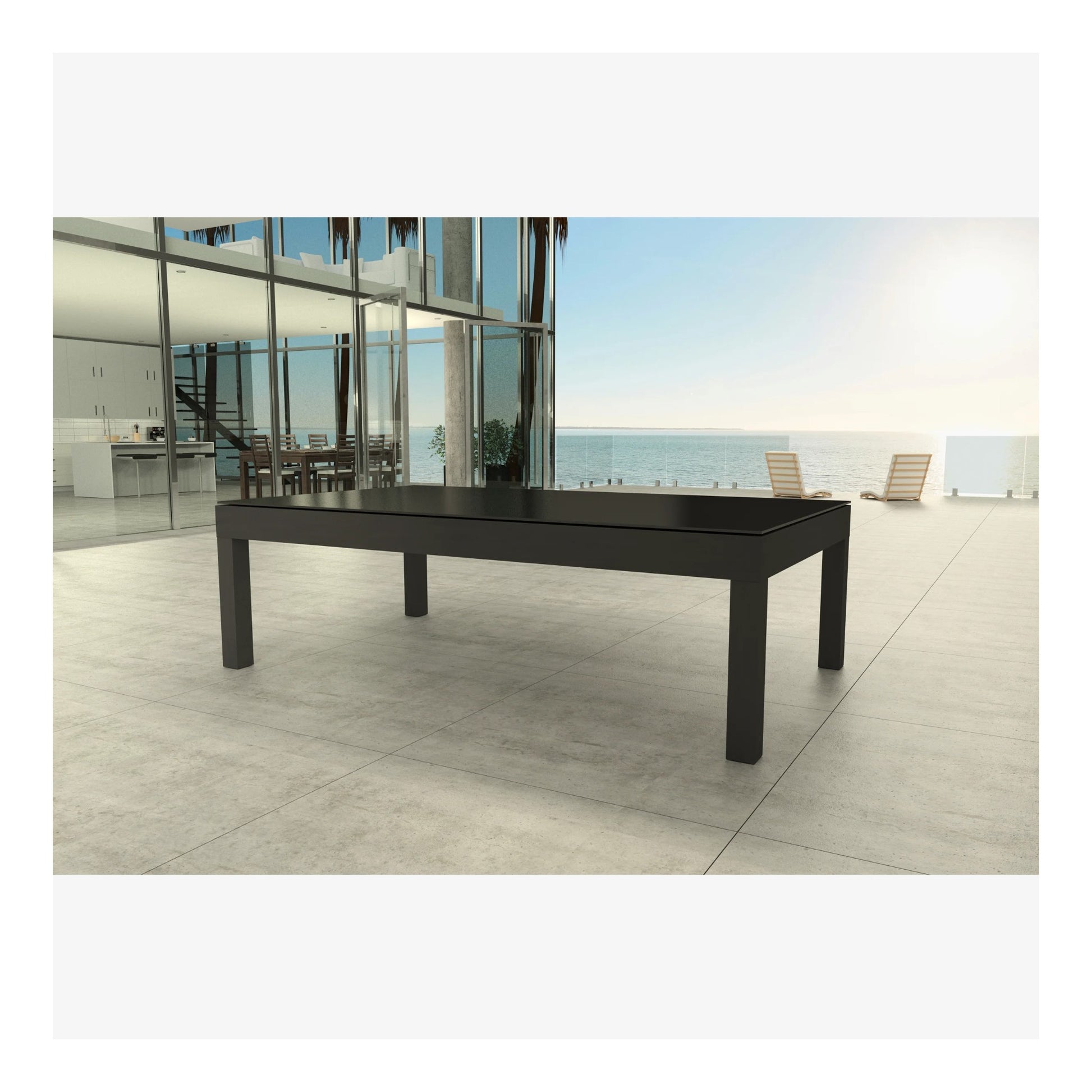 Black outdoor dining table on a patio with ocean view