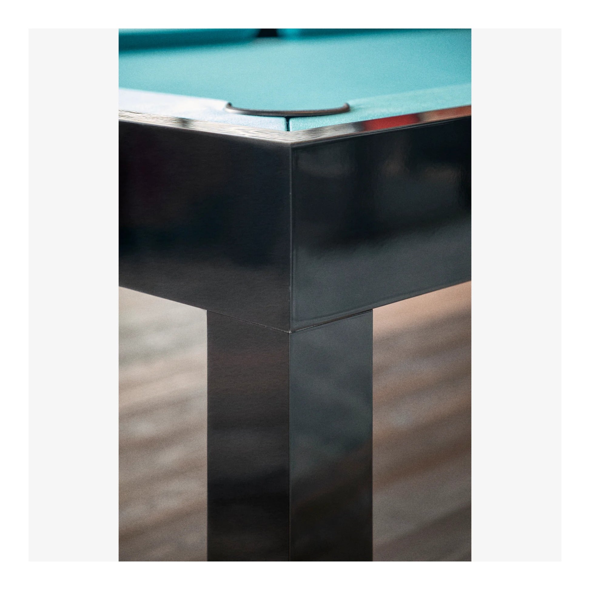 Close-up of the Storm pool table's corner pocket and black aluminum rail.