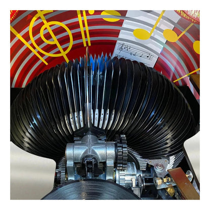 Close-up of a mechanical device with a colorful musical-themed background