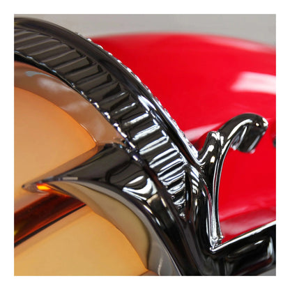 Close-up of a shiny chrome emblem on a jukebox.