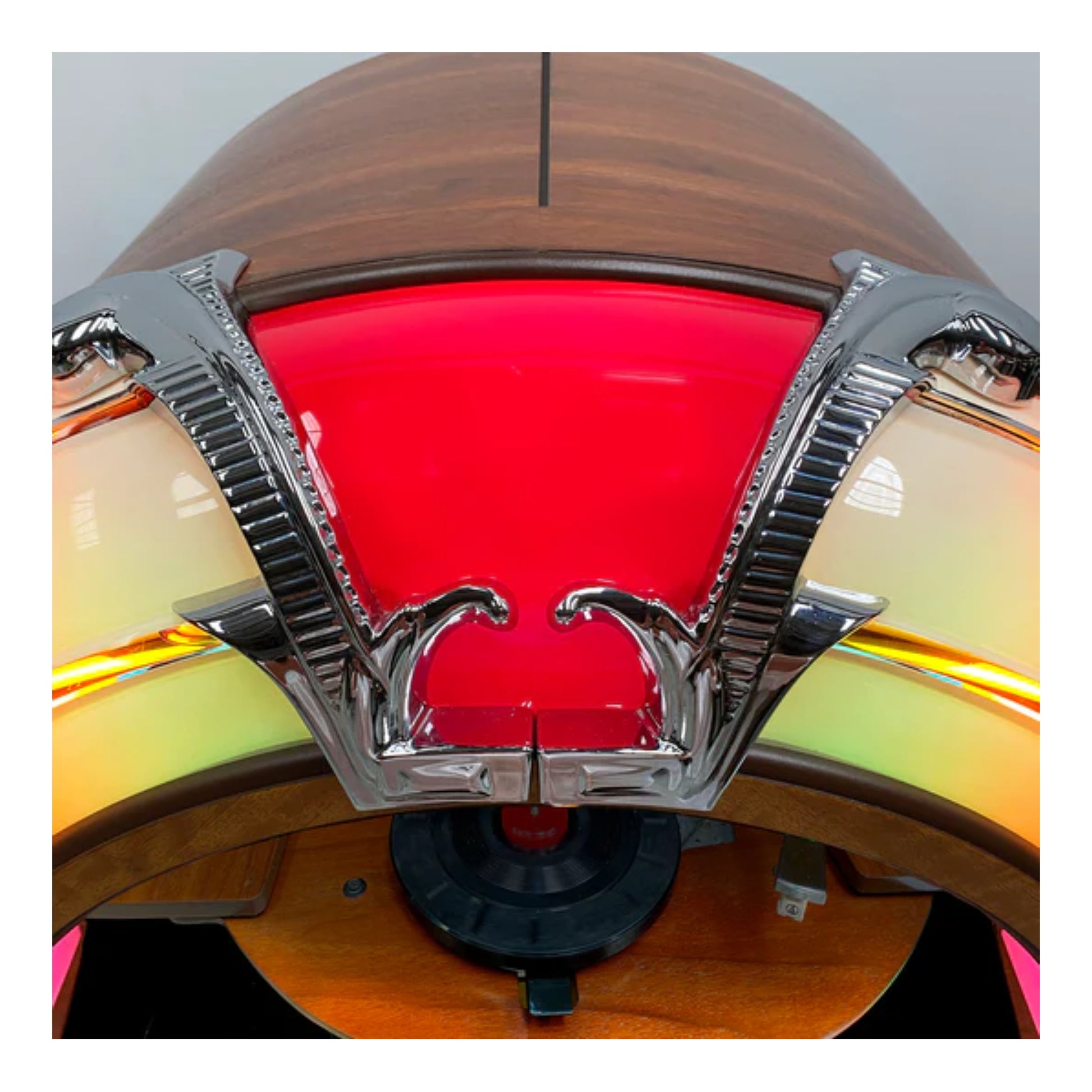 Close-up of a vintage-style light fixture with a red glass cover and wooden frame.