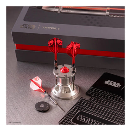 Star Wars-themed dart set with red and silver darts on a gray surface.