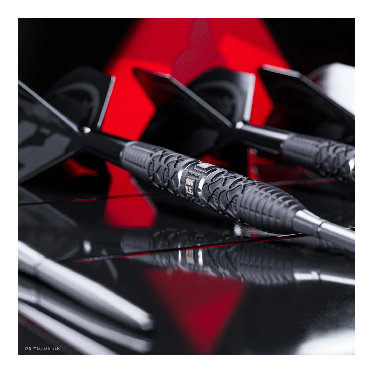Close-up of black darts with a red and black background