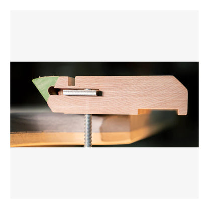 Wooden record player tonearm with a needle on a white background