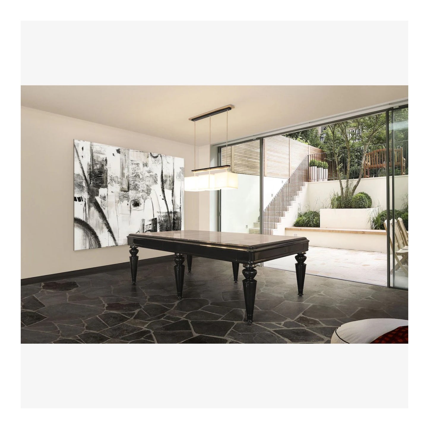 Modern living room with a large painting on the wall and a glass door leading to an outdoor area.