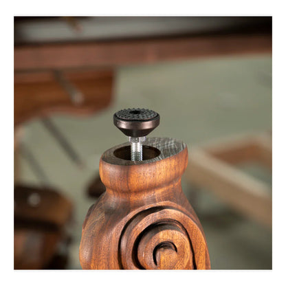 Wooden pepper grinder with metal top on a blurred background